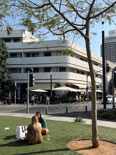 Tel Aviv Dizingoff Square with girls sitting on grass