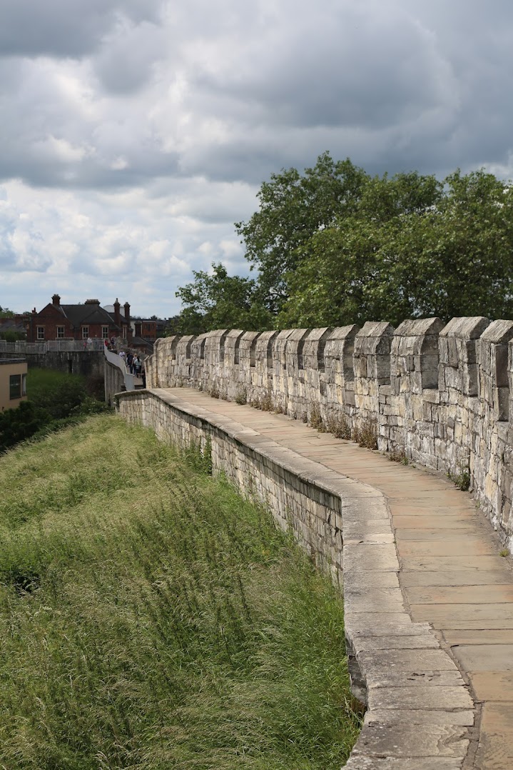 Old city walls of York with green patch - one of the best places to travel solo in europe