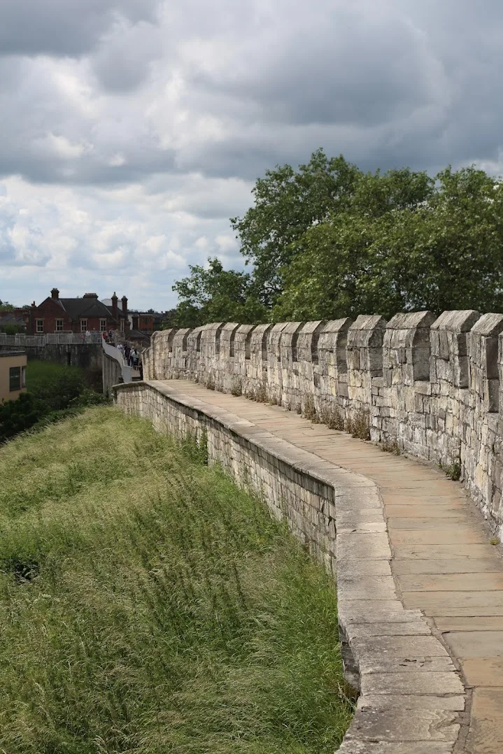 Old city walls of York with green patch - one of the best places to travel solo in europe