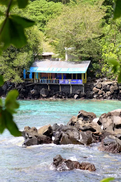 ternate beach with house on stilts and rocks