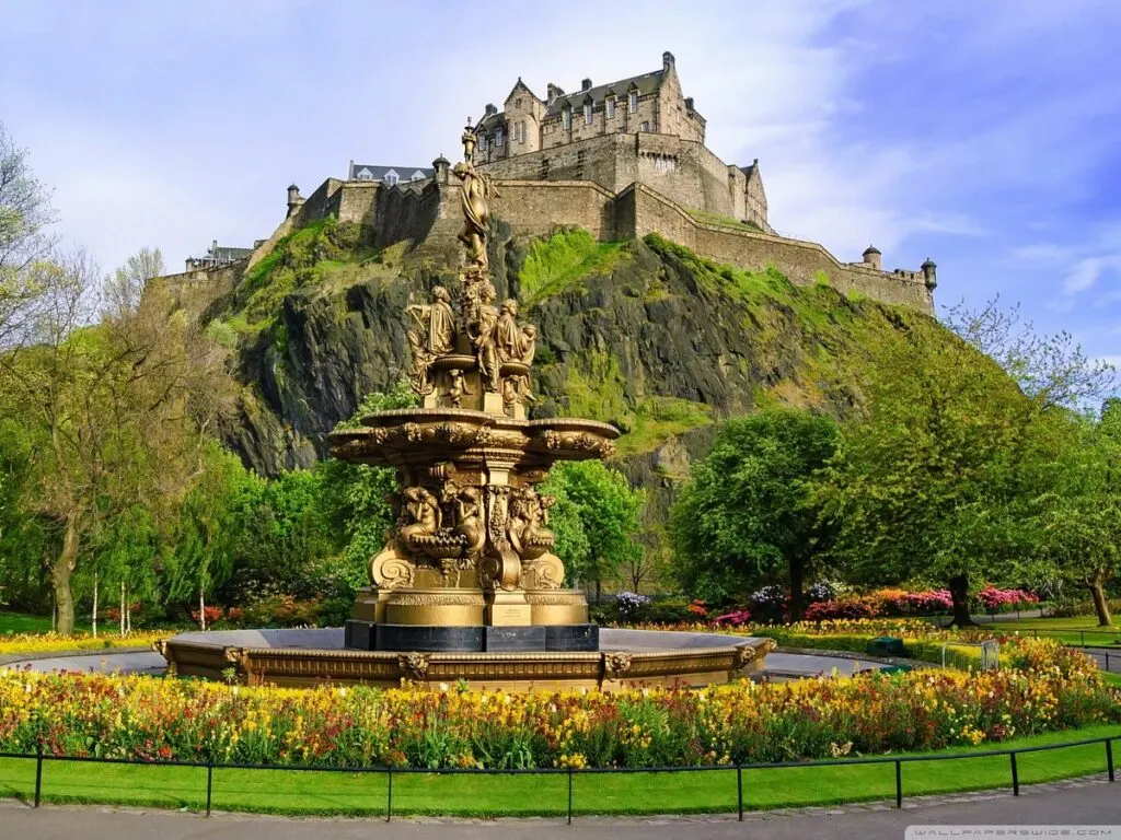 fountain in princes street gardens edinburgh scotland with edinburgh castle in the background