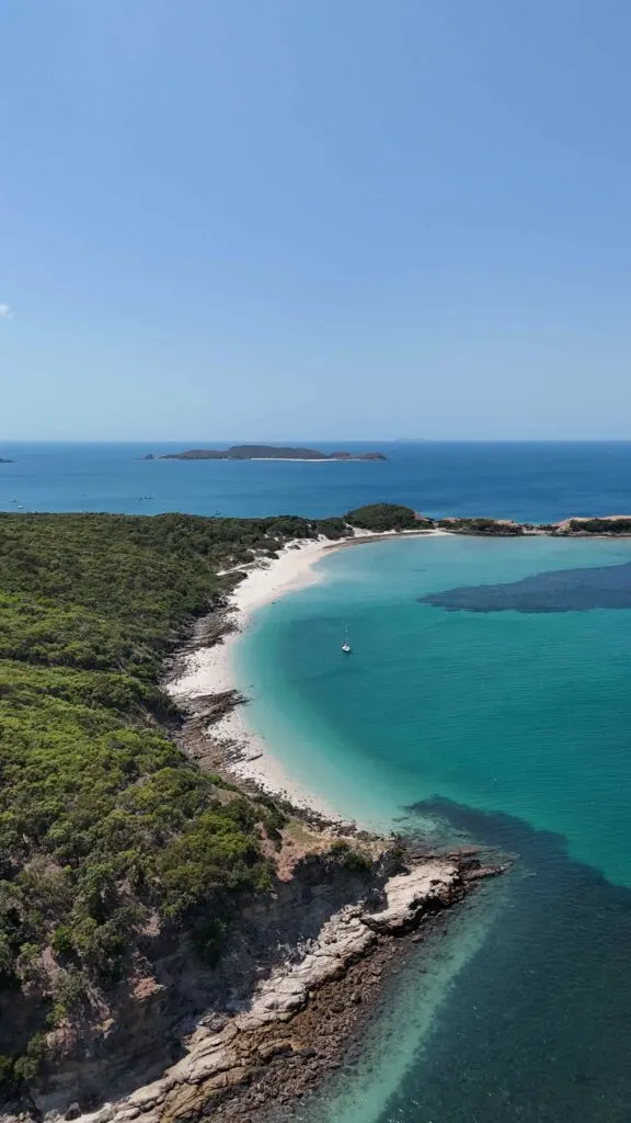 Drone shot of Monkey Beach's turquoise waters and reef off the shore.