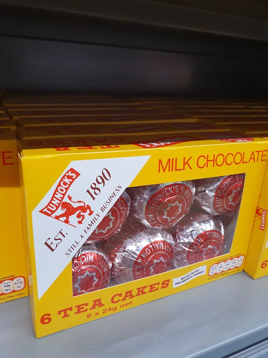 six tunnock's teacakes in a yellow box on a supermarket shelf in scotland