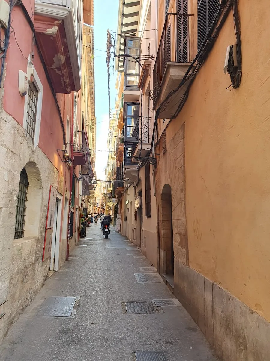 a narrow street with colorful buildings in palma de mallorca spain
