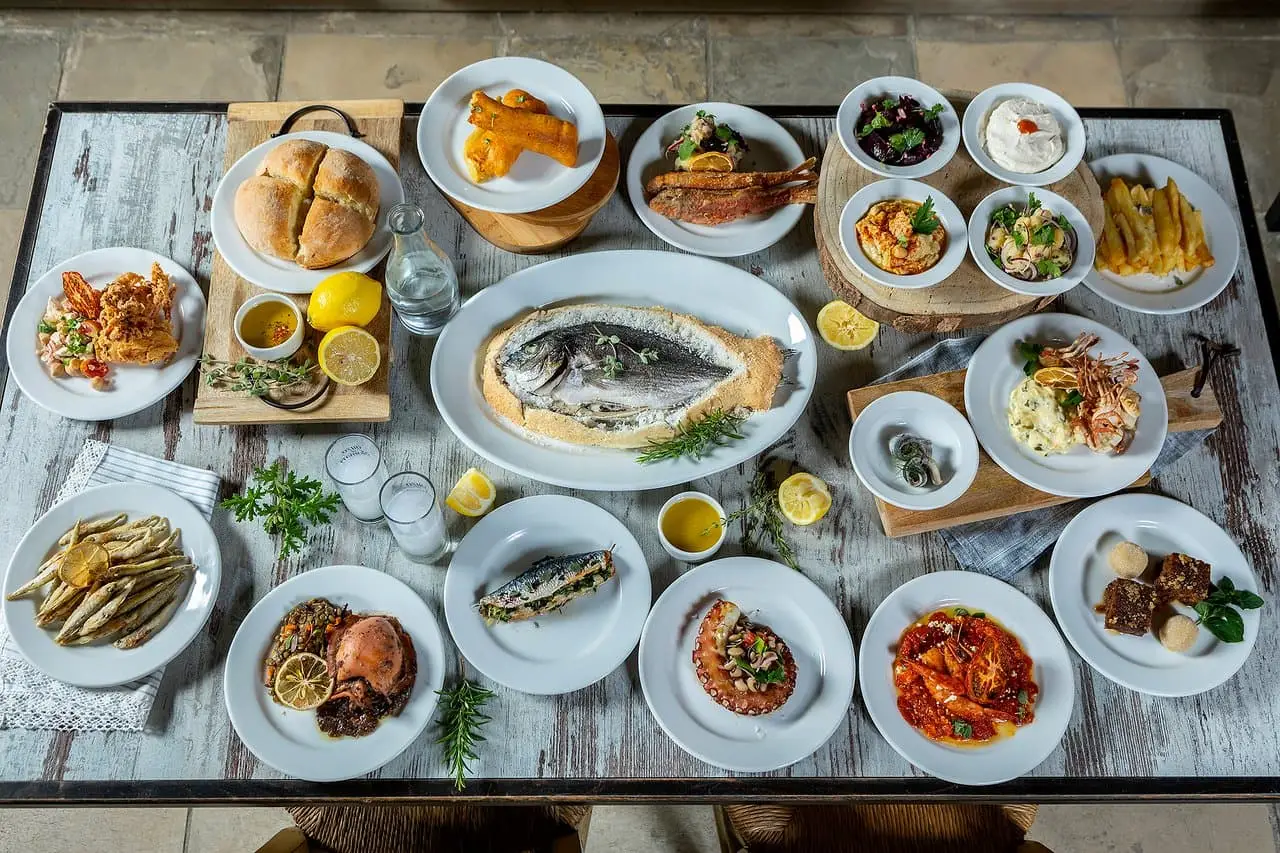 a table covered with white plates making up a fish meze from to arxontikon a greek restaurant in larnaca cyprus