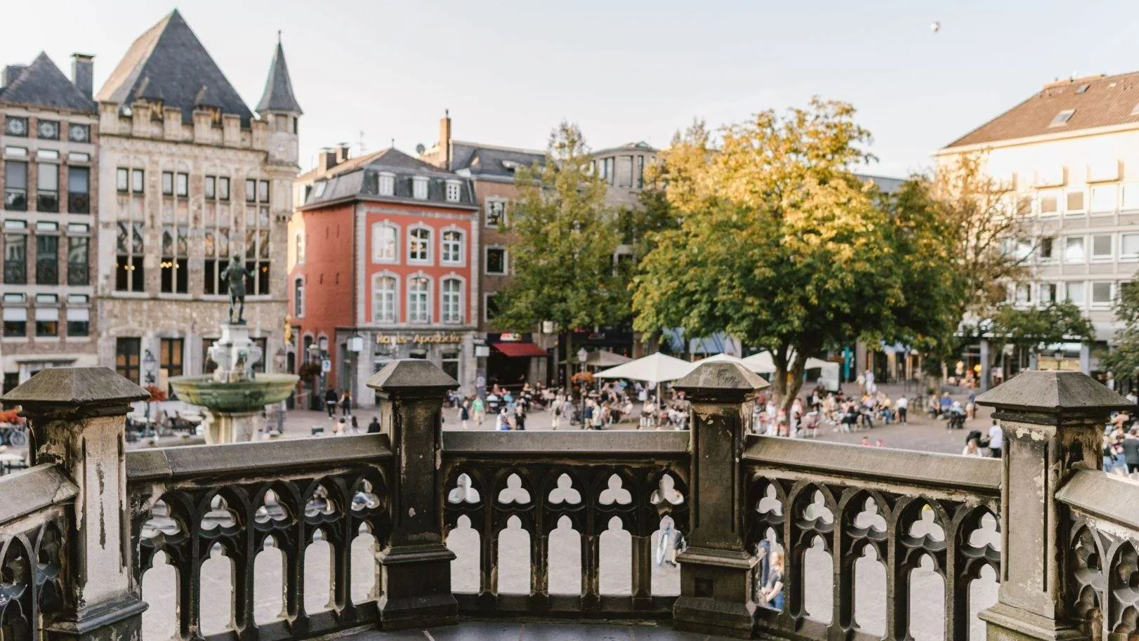 A town square seen in Aachen with people in it 