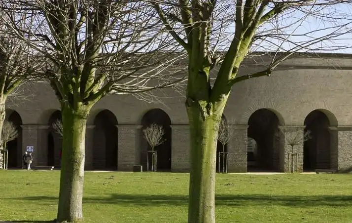 Roman amphitheatre seen behind trees at Xanten's Archaeological Park