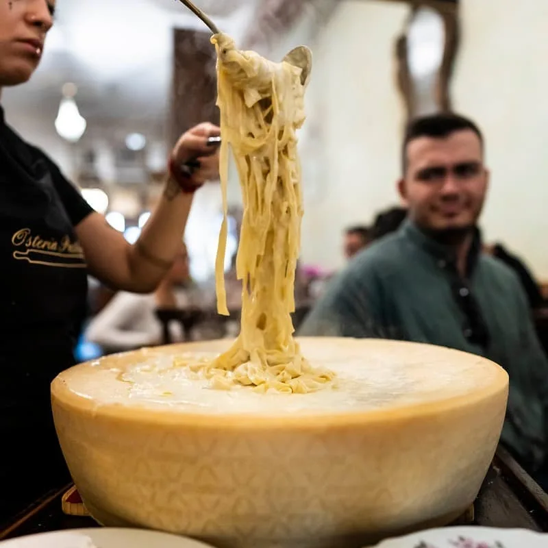 Famous pasta dish finished in the cheese wheel