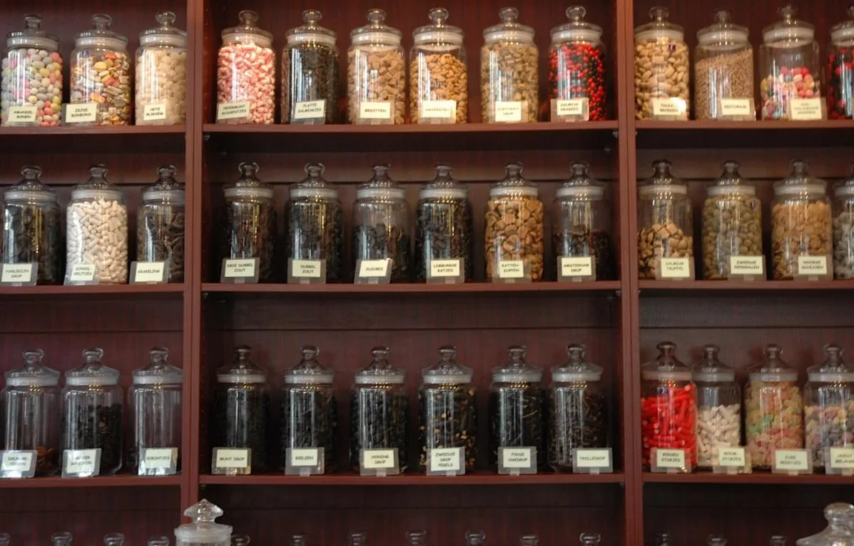 Sweets in glass jars on shelves in a sweets shop