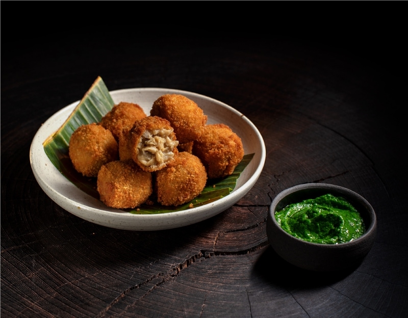 Bitterballen in a bowl with sauce next to them