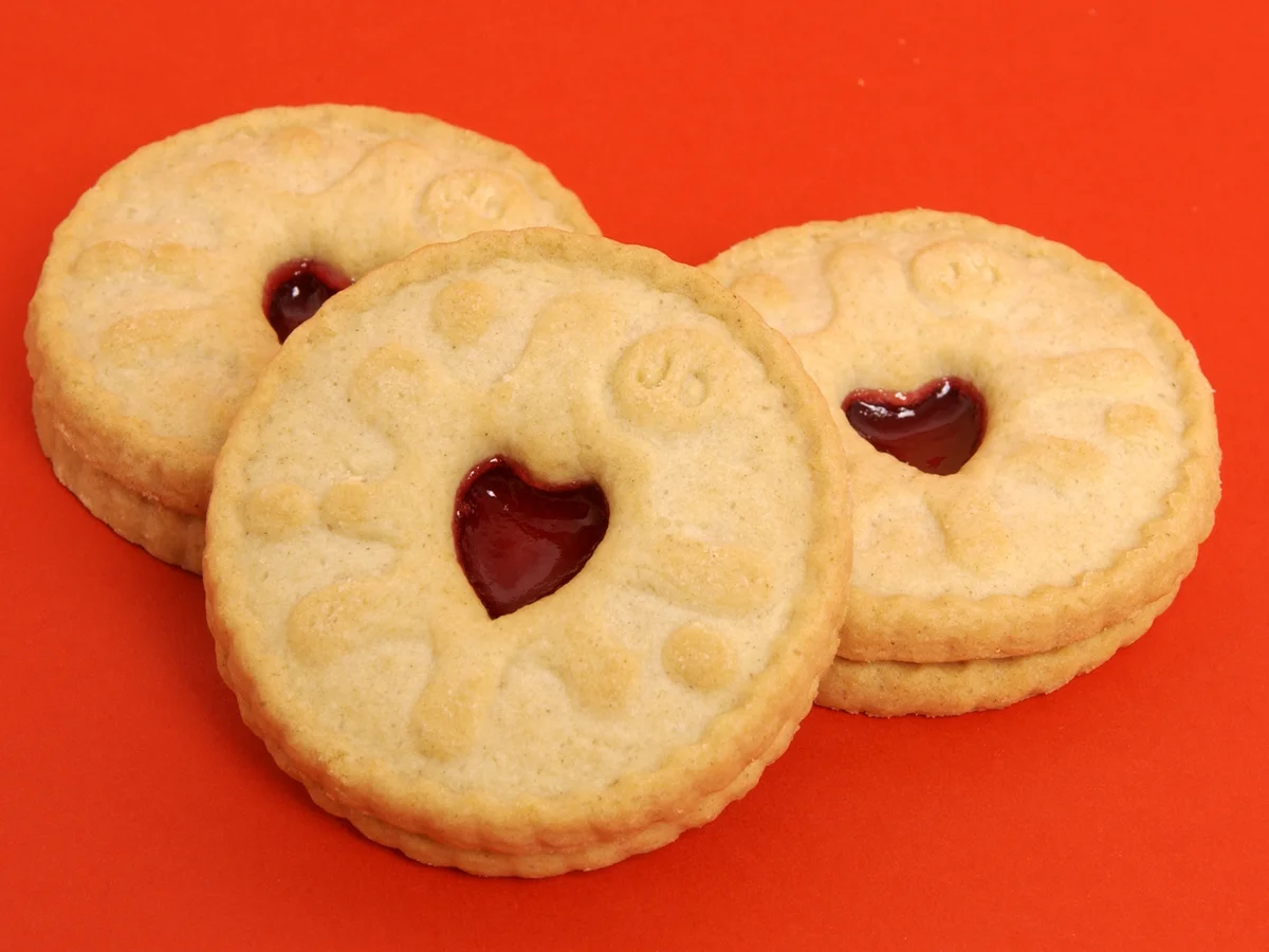 a jammie dodger is a shortcake biscuit with a heart shaped gap filled with jam a popular british snack