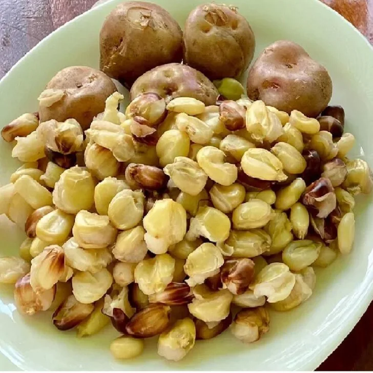Choclo corn and potatoes on a plate