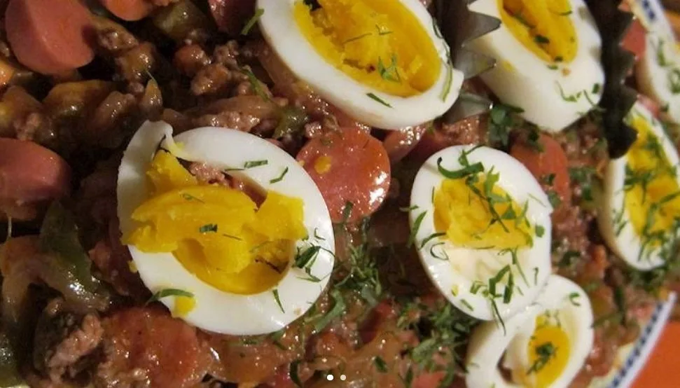 Pique macho, topped with boiled eggs, on a plate