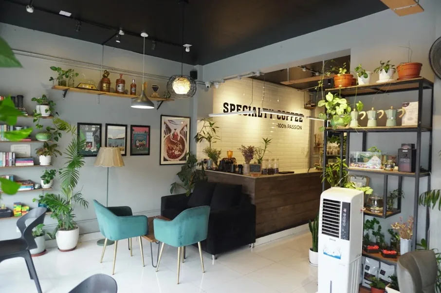 Interior of a coffee shop showing chairs, tables, and a counter