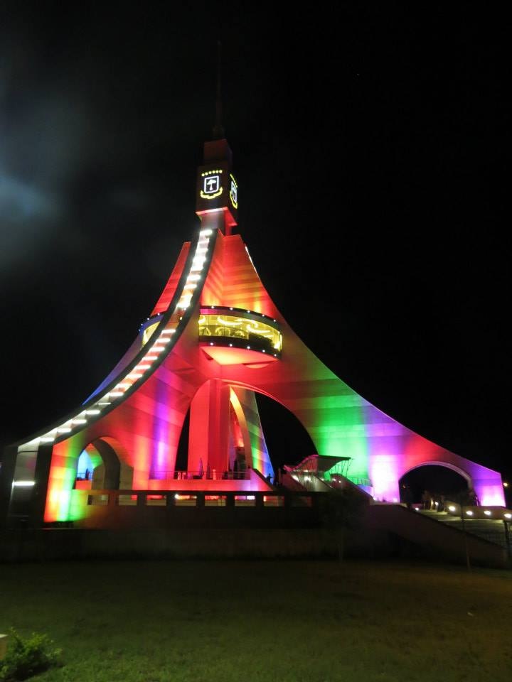 Torre de Libertad in Bata at night, lit up colorfully