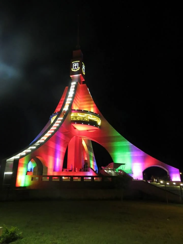 Torre de Libertad in Bata at night, lit up colorfully