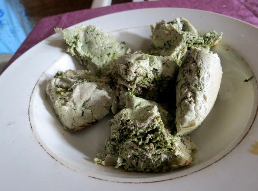 Fufu, or the insides of an envuelto, on a plate.