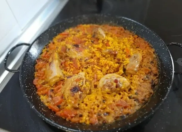 Paella with chicken in a big pan