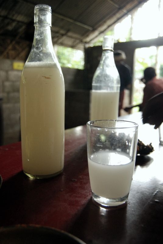Palm wine bottles and a glass