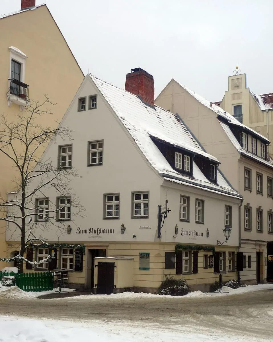 a historic white building home to Zum Nußbaum in Berlin Germany
