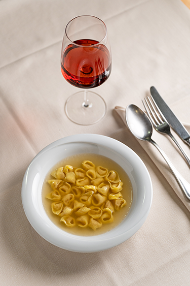 tortellini in brodo with a glass of rose wine from casa merlo bologna italy