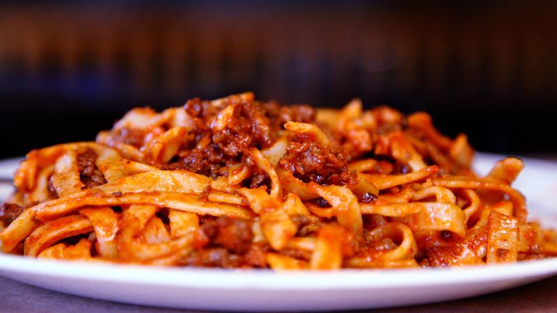 a plate of tagliatelle in bolognese sauce which inspired spaghetti bolognese