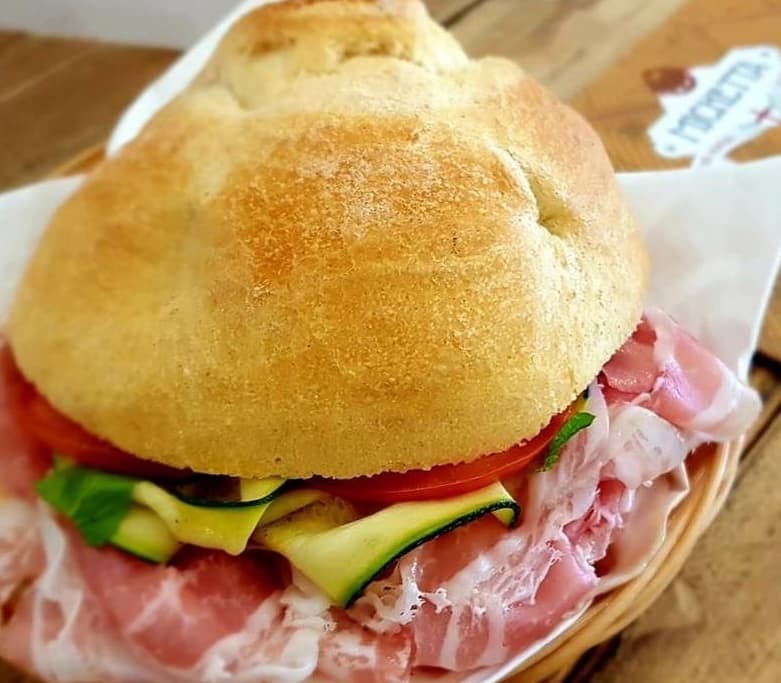 Michetta filled with cured meat, tomato and sliced courgette
