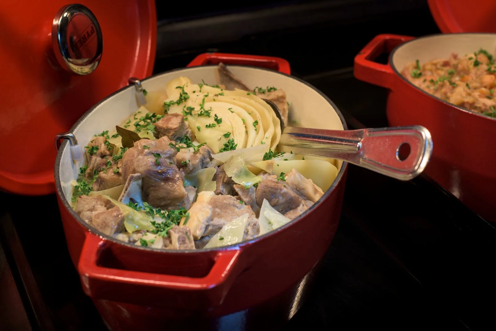 a red porcelain dish containing farikal a norwegian food dish of mutton and cabbage