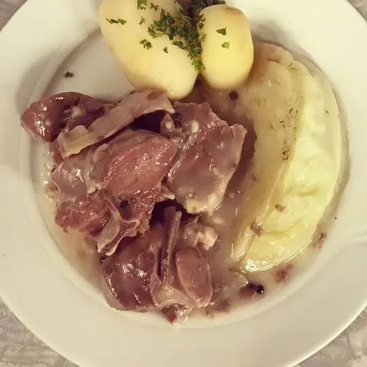 a plate containing farikal, the national dish of norway, comprising of mutton, cabbage and potato