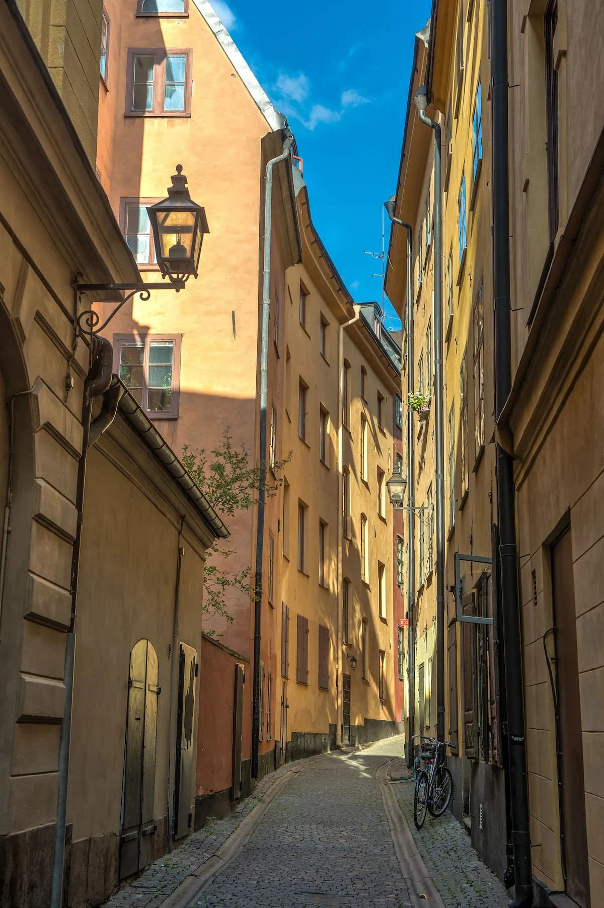 castle house inn backs on to a narrow street of colorful buildings in gamla stan stockholm sweden
