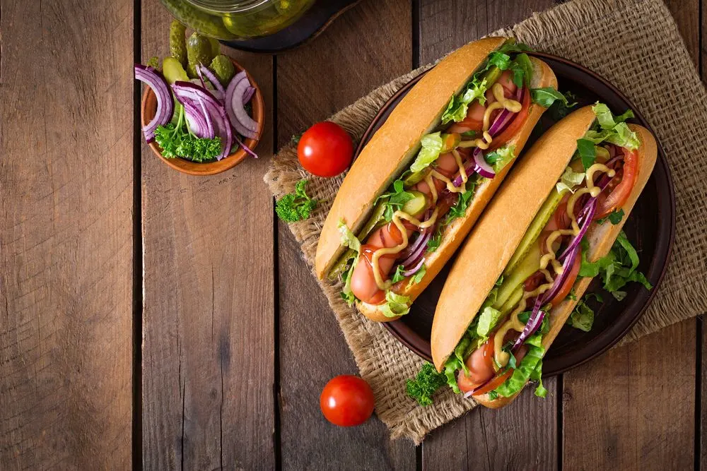 hot dog sausages in bread buns with salad and chimichurri sauce from haqet swedish street food in stockholm sweden