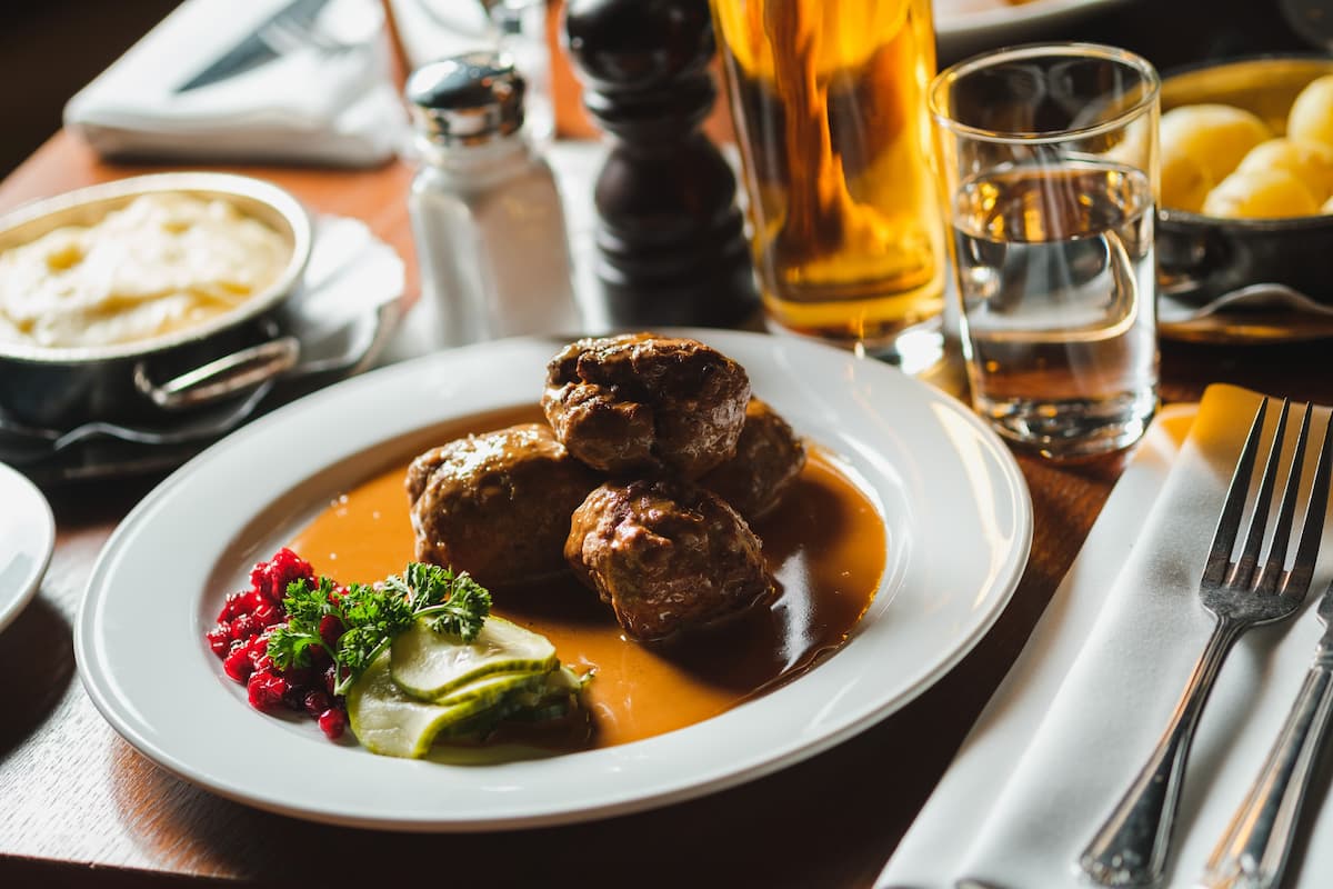 a white plate with swedish meatballs in gravy at pelikan restaurant in stockholm sweden
