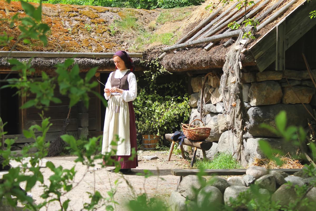 a lady in traditional swedish dress at skansen open air museum in stockholm sweden