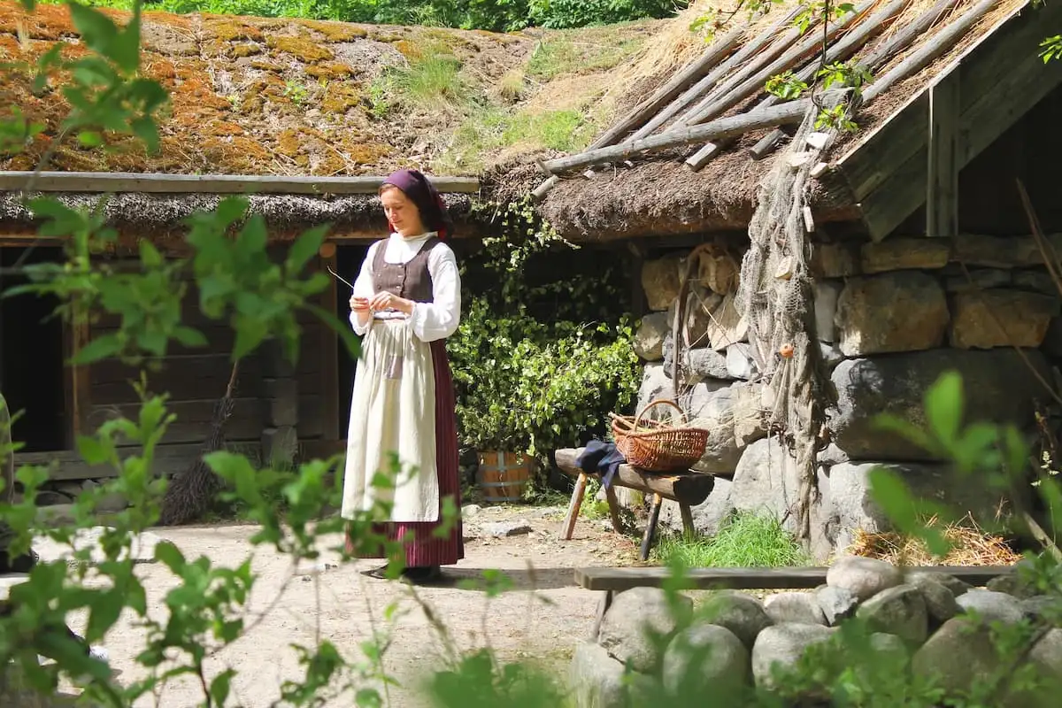 a lady in traditional swedish dress at skansen open air museum in stockholm sweden