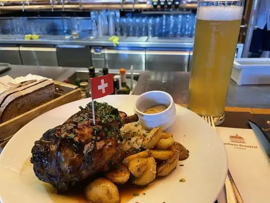 sirloin steak with potatoes and a pint of beer from rasthaus brauerei a swiss restaurant in lucerne switzerland