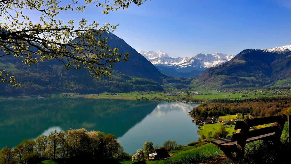 a body of water with mountains in the background is lake samersee a must see on a 1 week switzerland itinerary