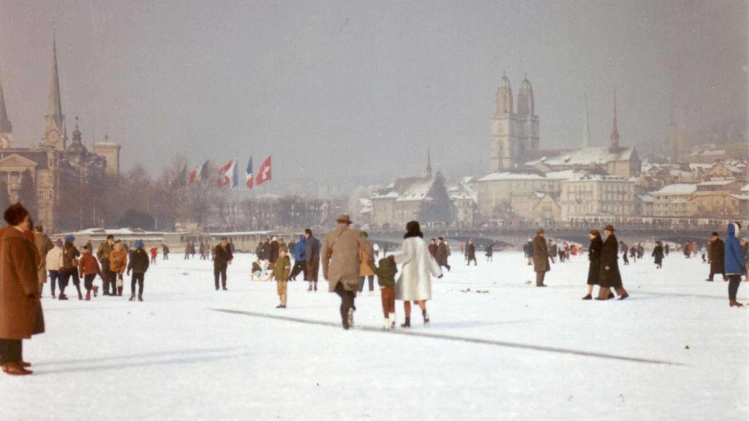 people walk and ice skate on the frozen surface of lake zurich switzerland