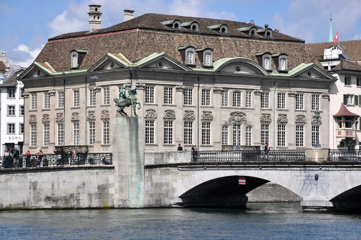 a stately home on a river bank is zunfthaus zur meisen a fondue restaurant in zurich switzerland