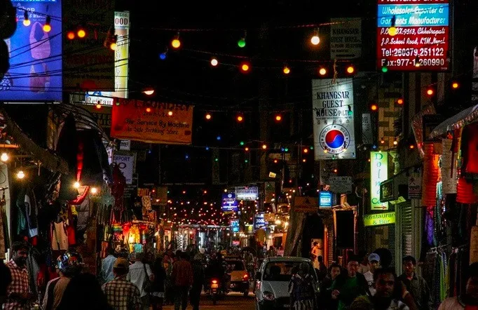 A brightly-illuminated street in Thamel