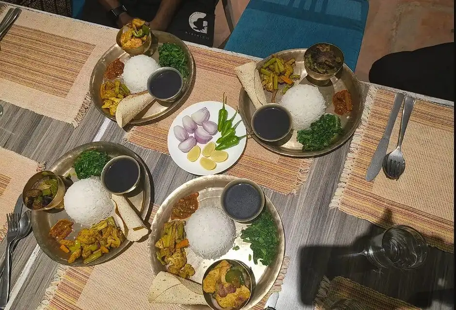 Table laden with assorted Nepalese thalis 