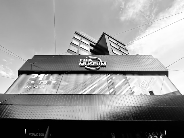a tall building with a sign reading fifa museum in zurich switzerland