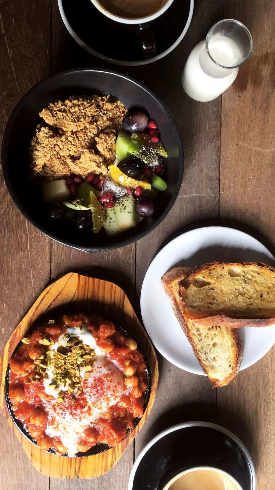 Granola with fruit salad and shakshuka