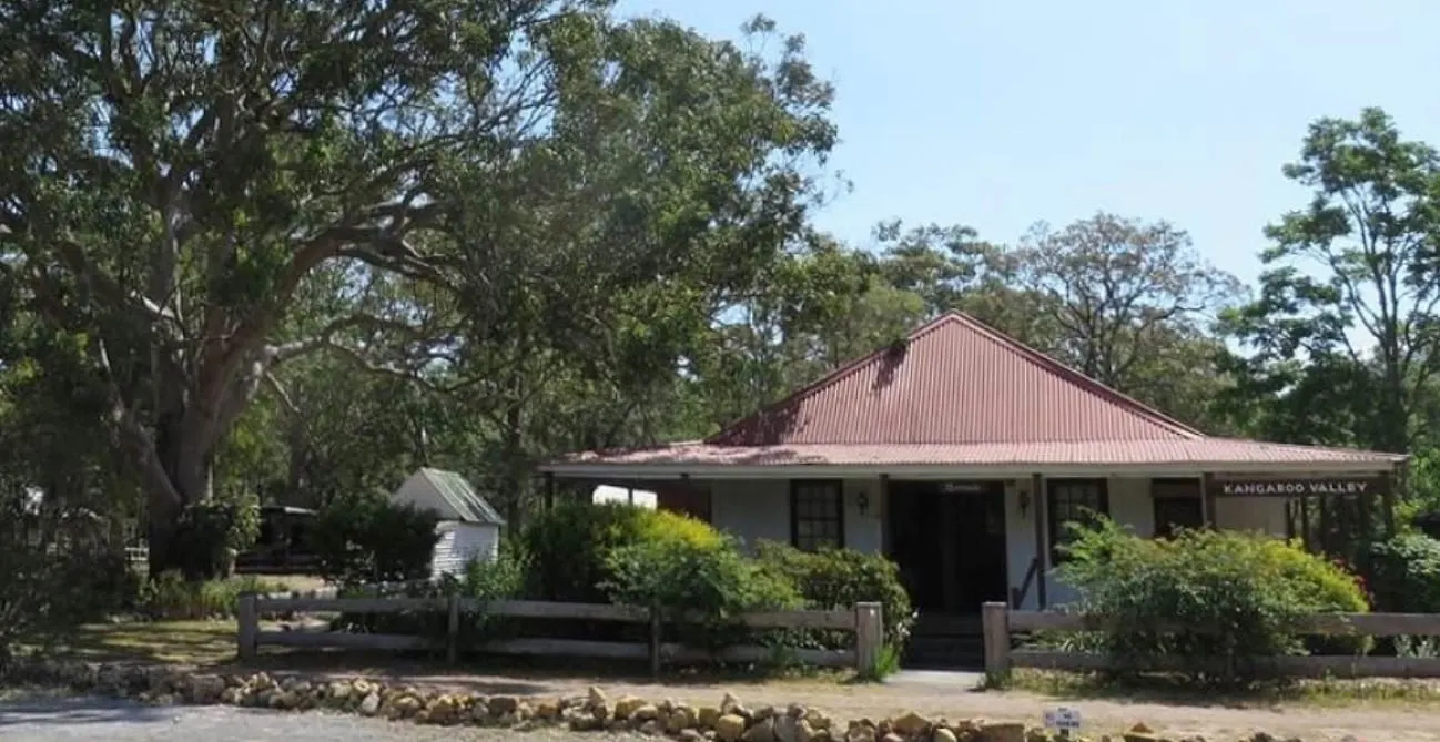 A historic building next to a large eucalyptus tree