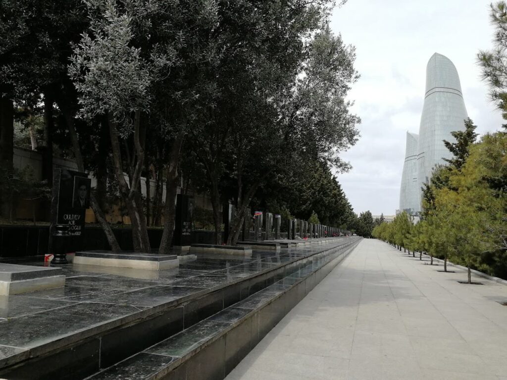 a black marble memorial to the lives lost in the first nagorno-karabakh war on the alley of martyrs in baku azerbaijan with the flame towers in the background