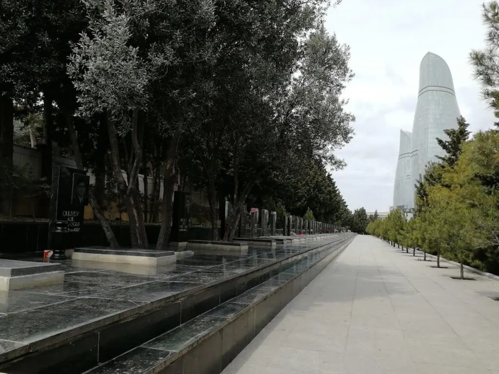 a black marble memorial to the lives lost in the first nagorno-karabakh war on the alley of martyrs in baku azerbaijan with the flame towers in the background