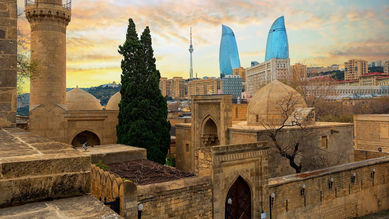 the walls of the ancient palace of the shirvanshah in baku azerbaijan with the flame towers in the background