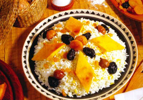 a plate of saffron rice topped with gara and herbs is known as plov the national dish of azerbaijan