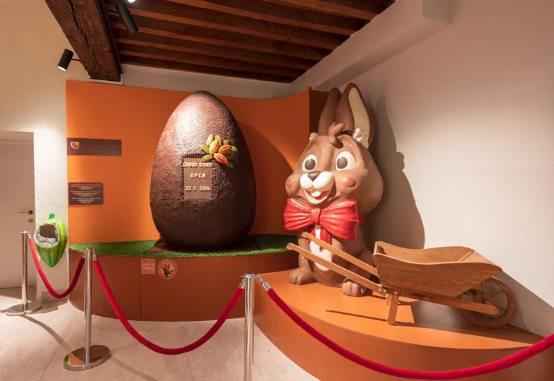 a giant chocolate easter egg and chocolate bunny at choco-story a belgian chocolate museum in bruges belgium
