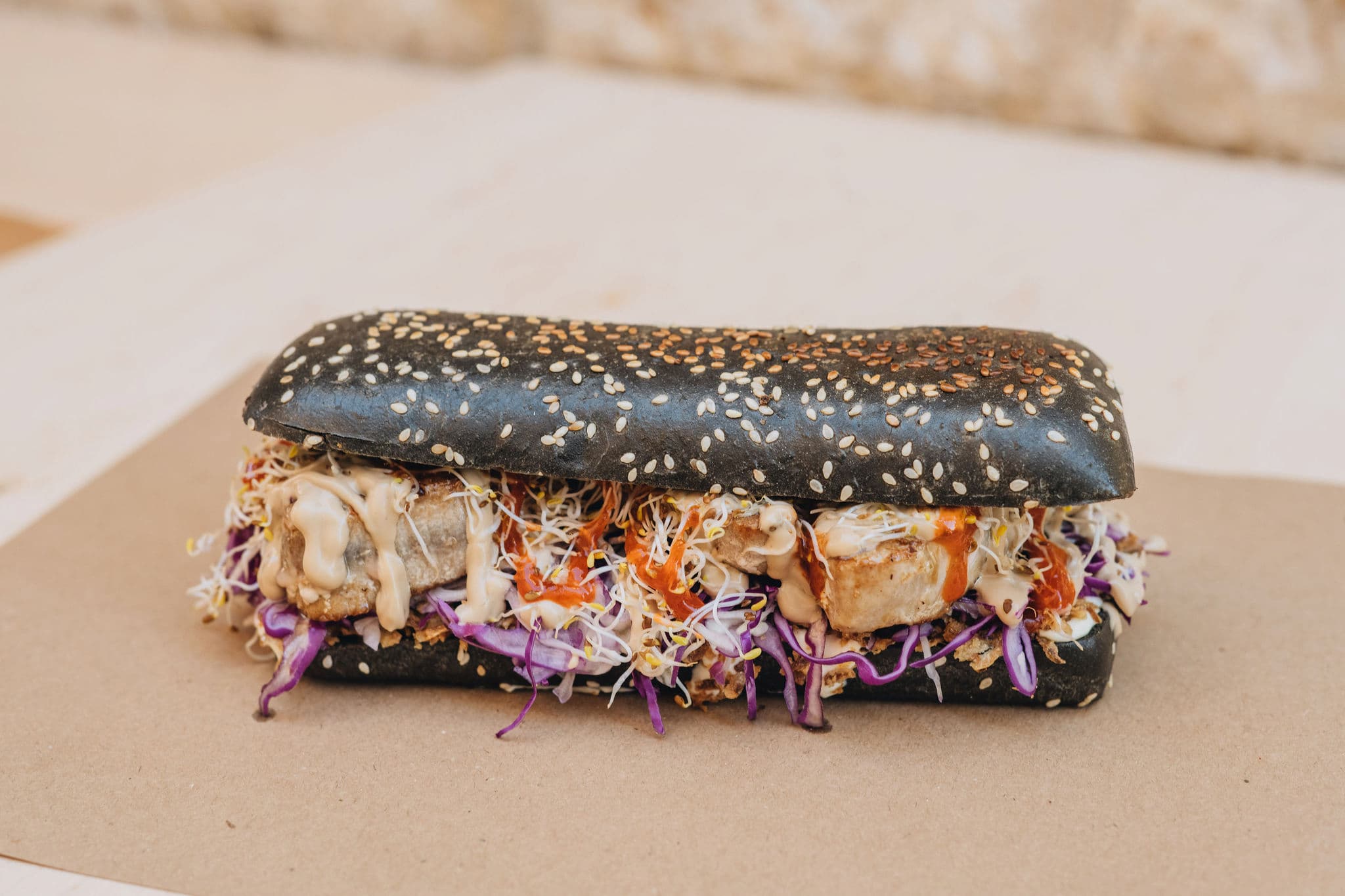 a tuna steak sandwich in a black hot dog bun from tunaholic fish bar in trogir croatia
