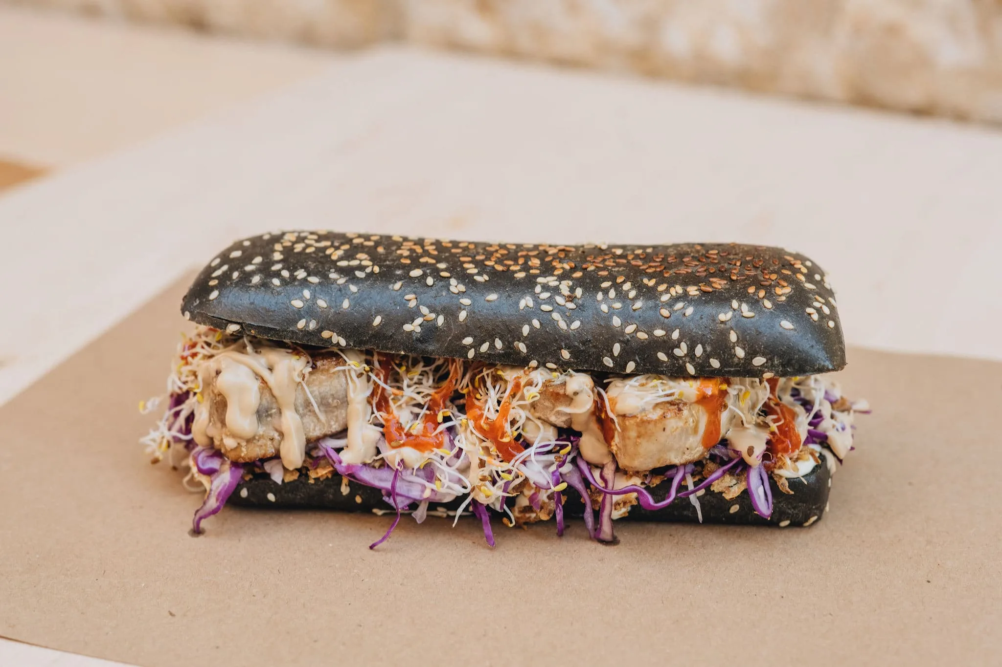 a tuna steak sandwich in a black hot dog bun from tunaholic fish bar in trogir croatia